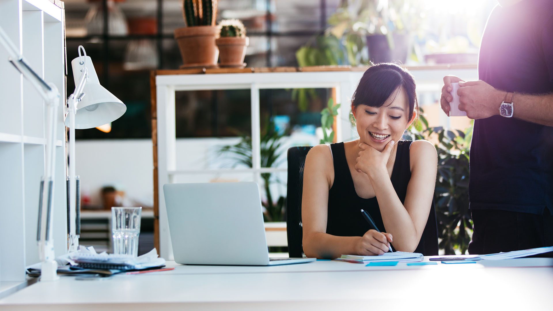 financial-planning-woman-sitting-on-desk financial-planning-woman-sitting-on-desk